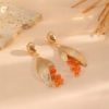 Gold leaf earrings on model